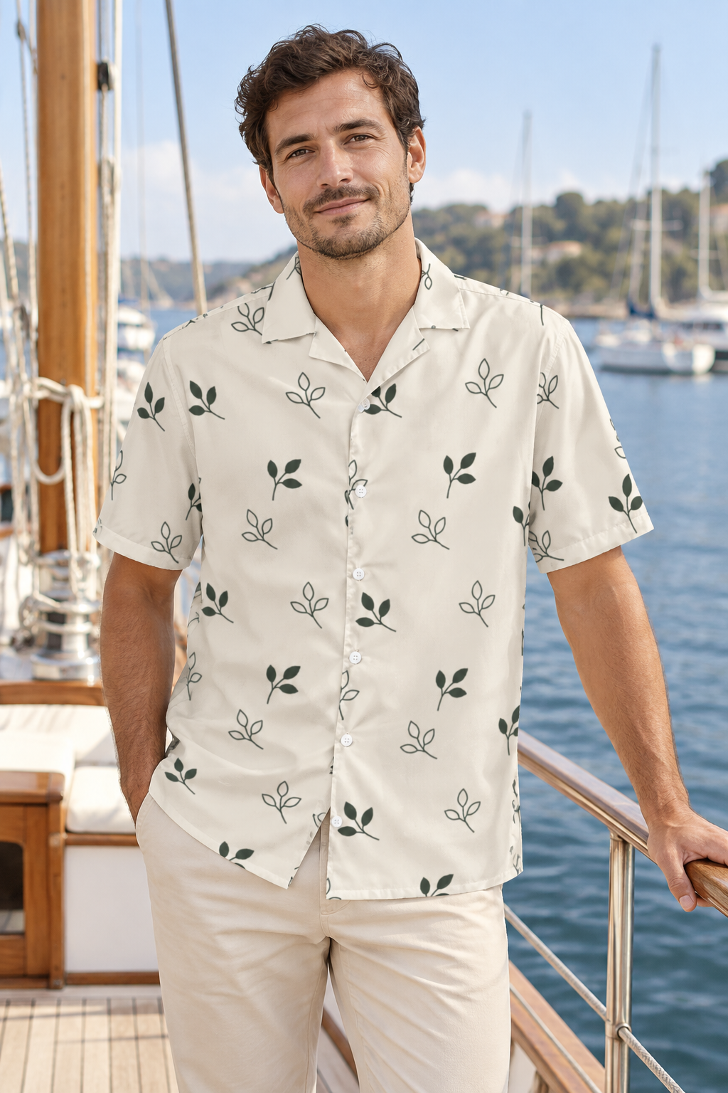 AI image of a fictional adult wearing the oat Open Grove button shirt with olive sprigs and white buttons on a boat in a marina.