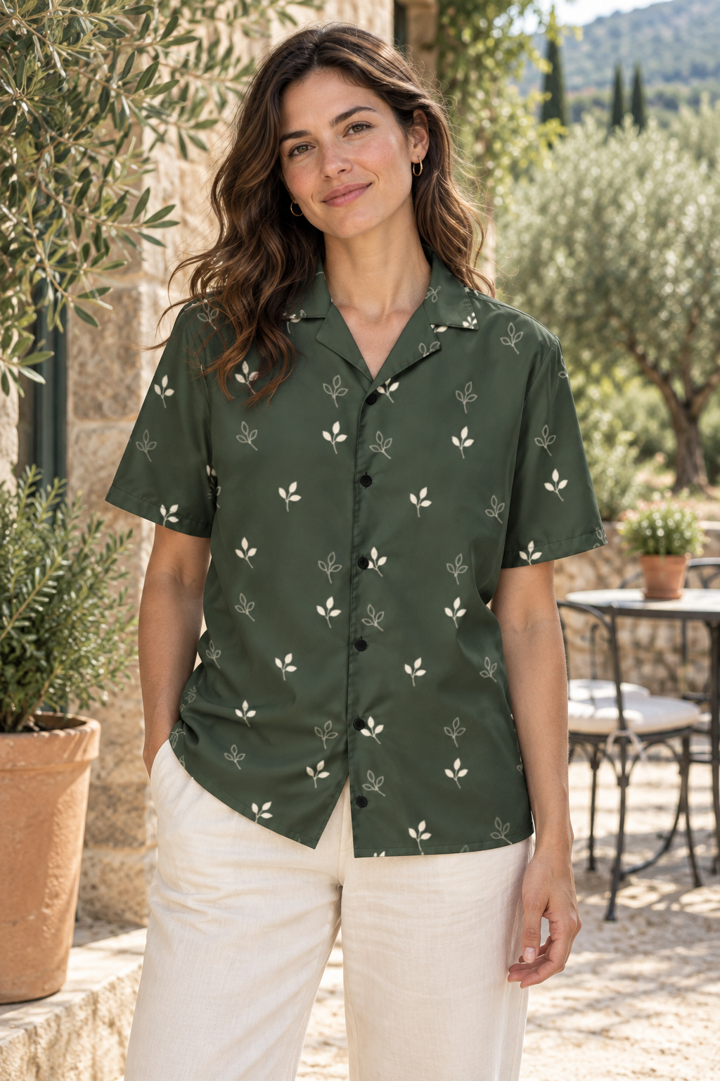 AI image of a fictional adult wearing the dark olive Olive Shade button shirt with small chalk sprigs and black buttons in a garden café.
