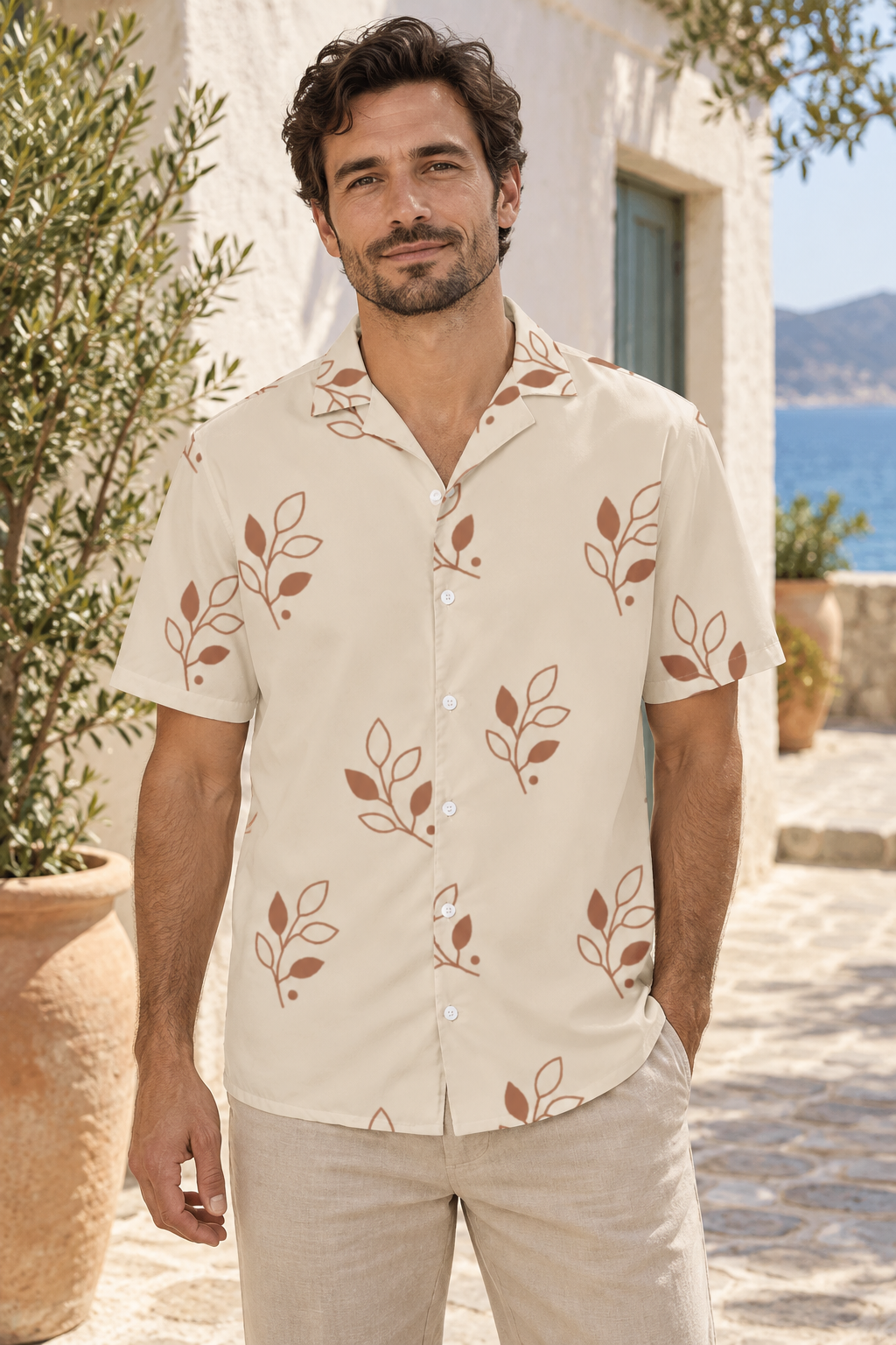 AI image of a fictional adult wearing the sand Clay Canopy button shirt with large clay branches and white buttons in a coastal courtyard.
